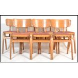 A set of seven vintage retro 20th century beech stacking chairs in the manner of Ben chairs raised