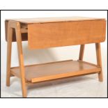 A mid 20th century retro teak two tier  buffet trolley / side table raised of angular form, being