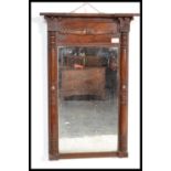 A late Victorian mahogany pier mirror, having decorative turned columns flanking the rectangular