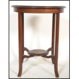 An Edwardian mahogany inlaid centre - occasional table being raised on slender, shaped legs with