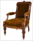 A Victorian 19th century mahogany library armchair being raised on reeded, turned legs with white