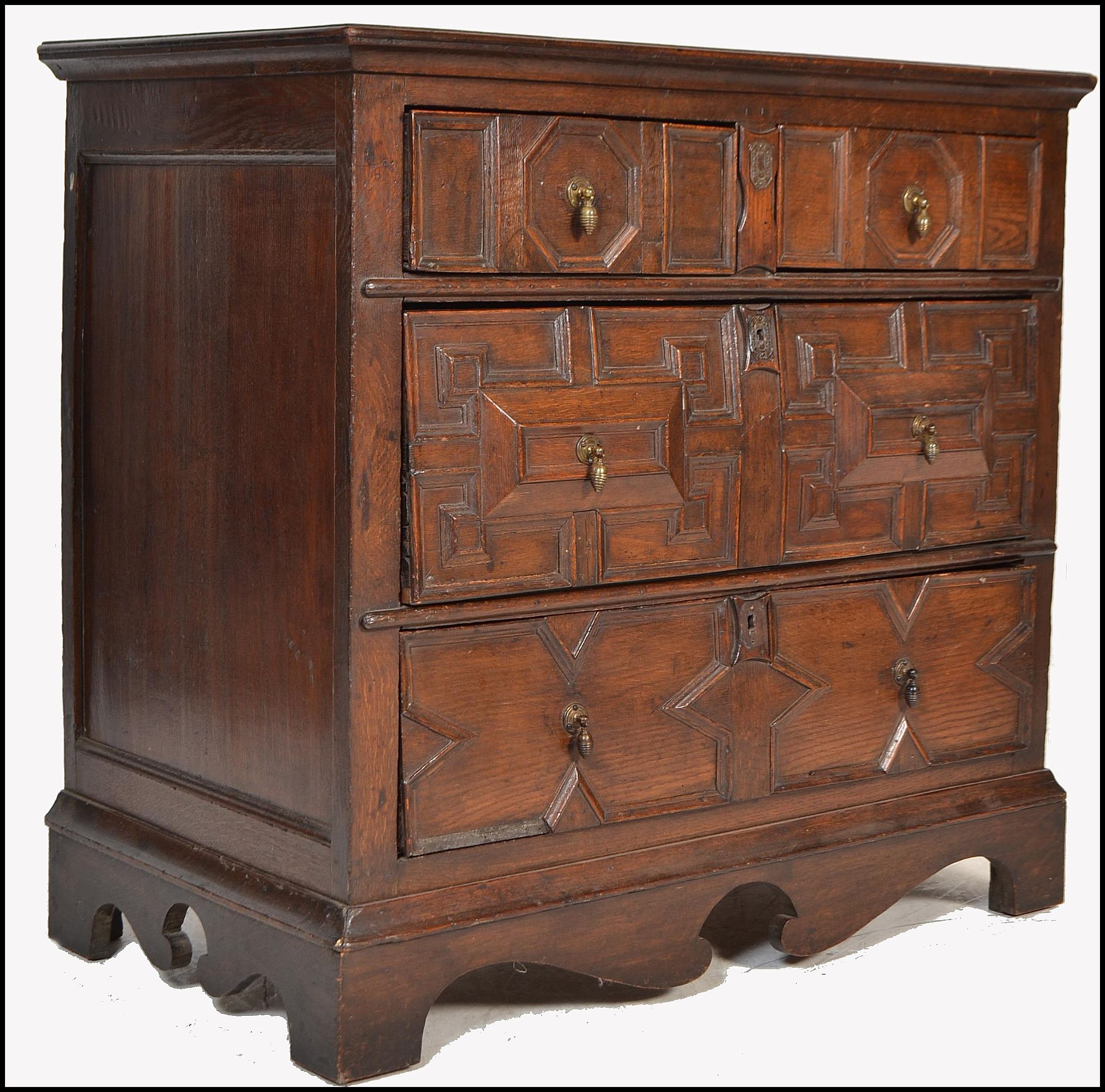 A 17th century Commonwealth oak block fronted chest of drawers. The bank of four drawers having