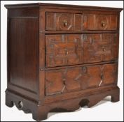 A 17th century Commonwealth oak block fronted chest of drawers. The bank of four drawers having