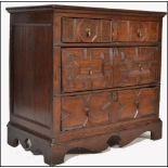 A 17th century Commonwealth oak block fronted chest of drawers. The bank of four drawers having