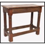 A 17th / 18th century country elm and oak joint stool. Unusual larger size with planked top over