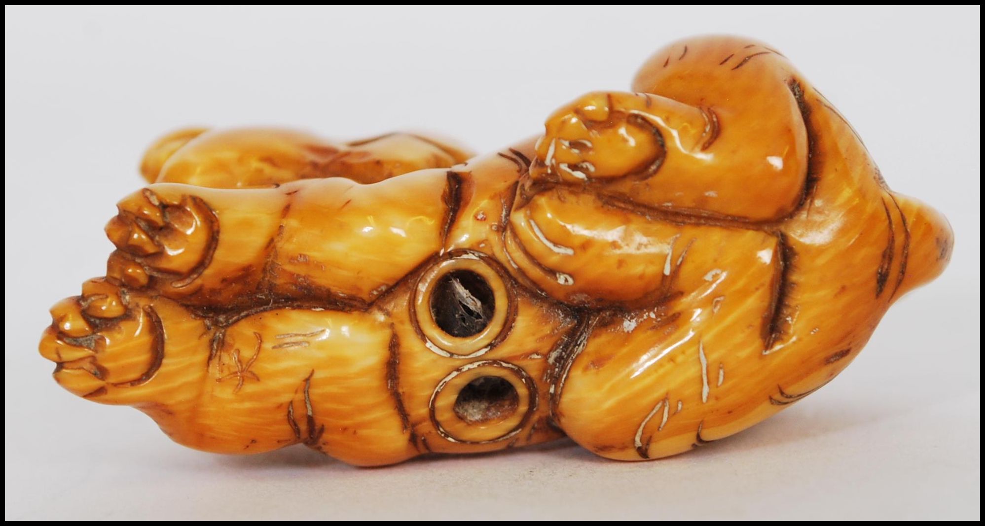 A rare Meiji period ivory Netsuke of a crouching tiger, its head turned back with long striped - Image 10 of 10