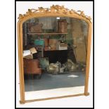 A large 19th century gilt wood and plaster arch top mirror. The large mirror with arch frame