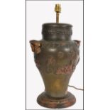 A 19th century large bronze twin handled vase lamp. Of Chinese influence being embellished with