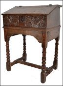 A 17th century Jacobean oak clerks desk / bible box on stand. The hinged sloping lift up top with