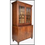 A Georgian 18th / 19th century flame mahogany library bookcase cabinet. Raised on shaped legs with