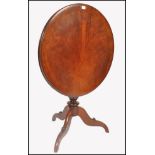 An 18th century George III solid mahogany tilt top occasional / wine table. Raised on splayed legs