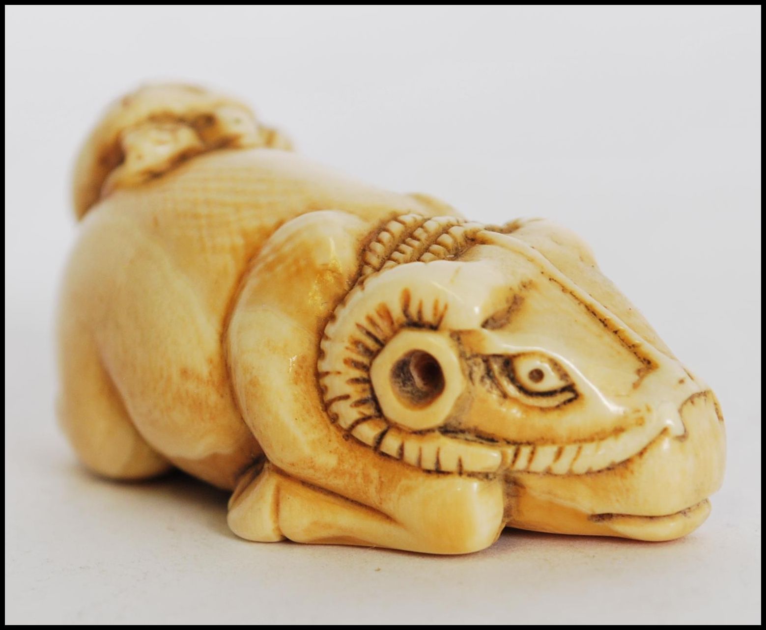 A rare and unusual 19th century Meiji period ivory Netsuke of a crouching / seated ox with - Image 2 of 6