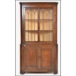 A 19th century large oak corner display cabinet / cupboard. Raised on bracket feet with twin door