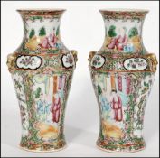 A pair of 19th century Chinese Canton vases.ÿEach of baluster formÿ with waisted necksÿ applied with