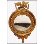 A Regency 19th century George III period eagle adorned convex wall mirror. The circular mirror