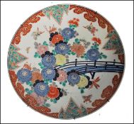 A large 19th century Chinese Famille Rose polychrome Charger. Painted with grasshopper's and