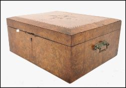 A 19th century walnut veneered work box of square form having quarter panel veneered lid with canted