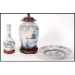 A group of 17th century Ming Dynasty Swatow ware items to include a jar / vase depicting figures