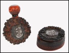 Two vintage early 20th century carved amber bakelite items consisting of a perfume bottle of moon