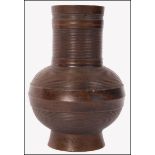 A believed 19th century Chinese Oriental bronzeÿ Gu vase of cyilndrical form with bulbous ribbed