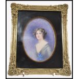 An early 20th century watercolour painting portrait miniature of a young girl debutante holding