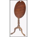 A 19th century George III solid mahogany tilt top wine table. Of slender proportions being raised on