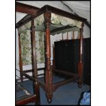 A mid Victorian 19th century solid mahogany four poster double bed. The footboard with tall tapering