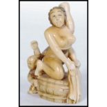 A Japanese Meiji period carved ivory netsuke in the form of a naked Geisha holding her hair whilst