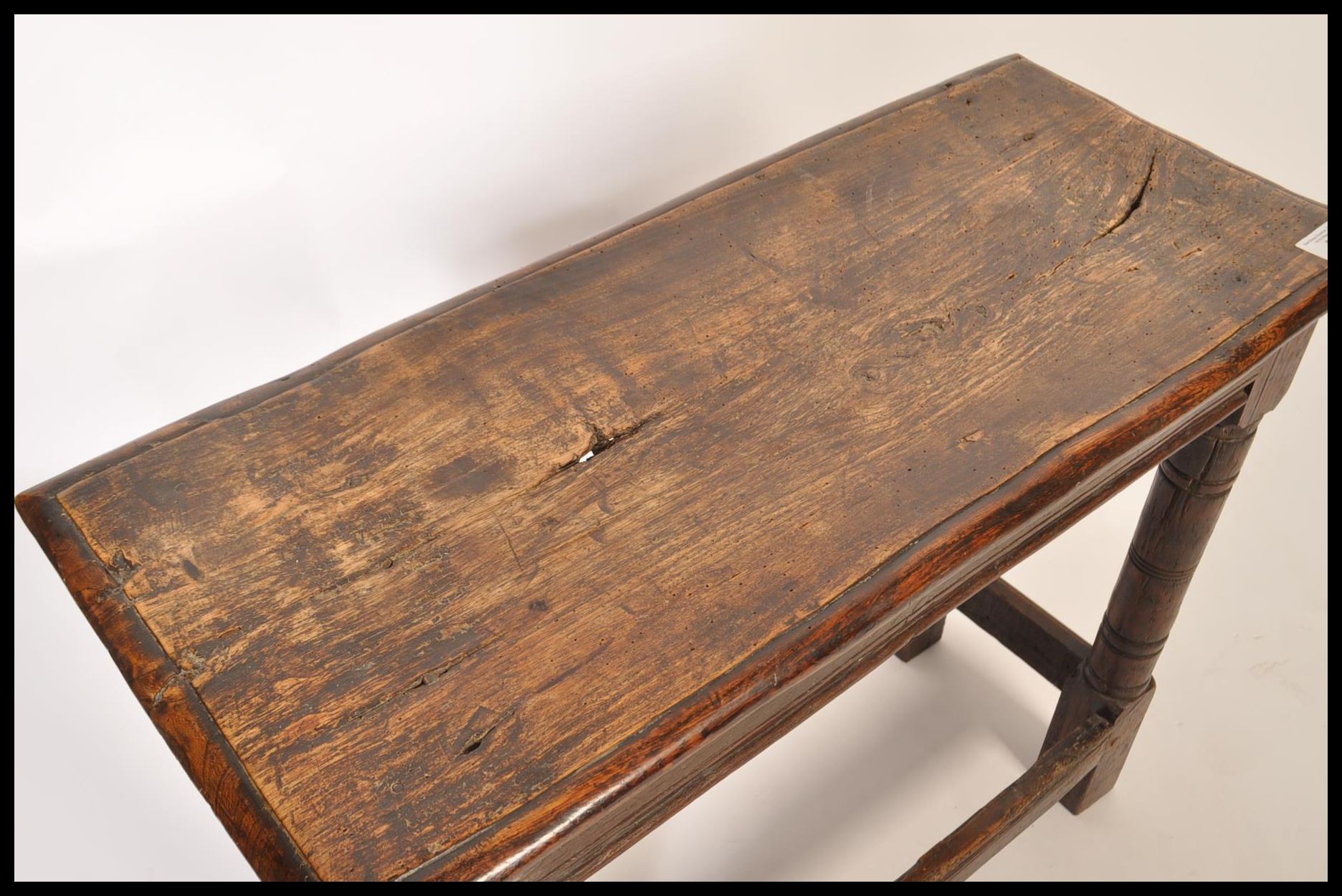A 17th / 18th century country elm and oak joint stool. Unusual larger size with planked top over - Image 5 of 16