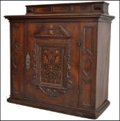 A 17th century oak Italian cupboard / cabinet. Raised over a banded plinth base with geometric