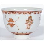 A Chinese Porcelain Tea Bowl possibl Yongzheng period, hand painted in iron red with double inverted