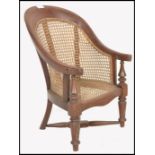 A 19th century Victorian childs bergere caned armchair. Raised on turned legs with cross stretchers.