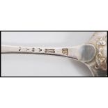 Two 18th century George III silver hallmarked shell back table spoons in the Hanoverian pattern