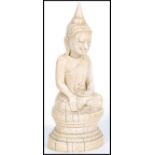 An 18th century Burmese carved ivory buddha sat in the lotus position with beatific expression,