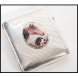 A silver hallmarked vesta cigarette case with an enamelled image of a horse and dog to the front.