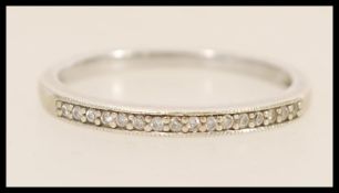 A hallmarked 9ct white gold ring set with diamond accent stones. Hallmarked Sheffield. Weight 2.
