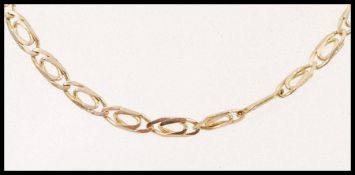 A 9ct gold decorative flat linked chain necklace with a lobster clasp. Weight 7.7g.