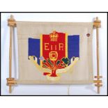 A vintage 20th century Royal QEII tapestry banner on turned wooden frame. 62cm high 74cm wide.
