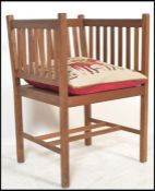 A 20th century Arts & Crafts  / Shaker revival teak wood armchair raised on squared legs with