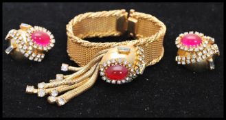 A vintage 1950s Hobé bracelet and earring set consisting of a mesh gold-tone bracelet set with a