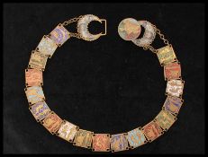A 1930s Czech Neiger Egyptian revival metal belt having enamel decorated links. Measures 26 inches.