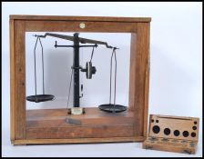 A vintage retro 20th century oak cased set of scientific apothecary weighing balance scales with