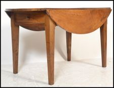 A 19th century large extending drop leaf French provincial cherry wood dining table. Raised on