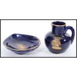 A porcelain miniature jug having a royal blue glaze with a gilt crest of the Order of the