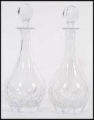 A pair of vintage 20th century cut glass crystal leaded decanters having faceted bulbous bodies with