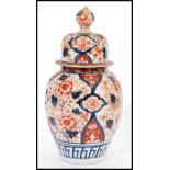 A 19th century Chinese Imari jar / vase / urn and cover having typical hand painted Imari decoration