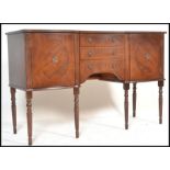 An 20th Century Regency revival mahogany veneered sideboard having brass ring handles and a