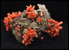 A vintage Frank Hess / Miriam Haskell spezzati coral coil bracelet having gold tone thistle