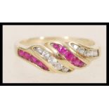 A stamped 375 9ct gold ring having pink and white stones set into the head. Weight 2.4g. Size M.5.