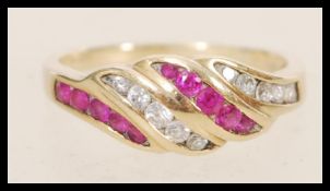 A stamped 375 9ct gold ring having pink and white stones set into the head. Weight 2.4g. Size M.5.